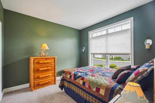 bedroom with carpet floors and baseboards