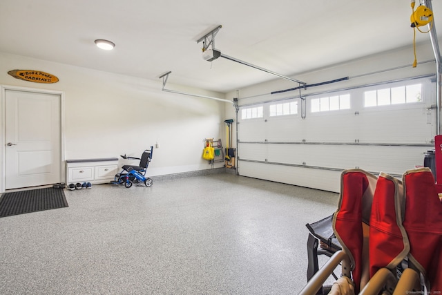garage with baseboards and a garage door opener