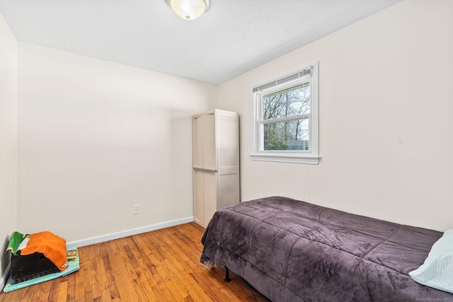 bedroom featuring baseboards and light wood-style flooring