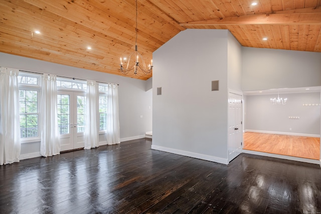 unfurnished living room with an inviting chandelier, wood ceiling, baseboards, and french doors