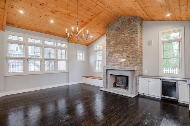 unfurnished living room featuring a notable chandelier, wooden ceiling, dark wood-type flooring, and wine cooler