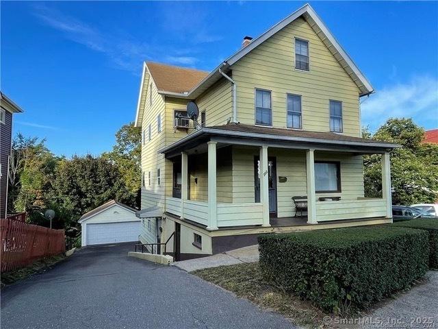 302 High St, Naugatuck, CT 06770 - view of front of home with an outdoor structure, a garage, and covered porch