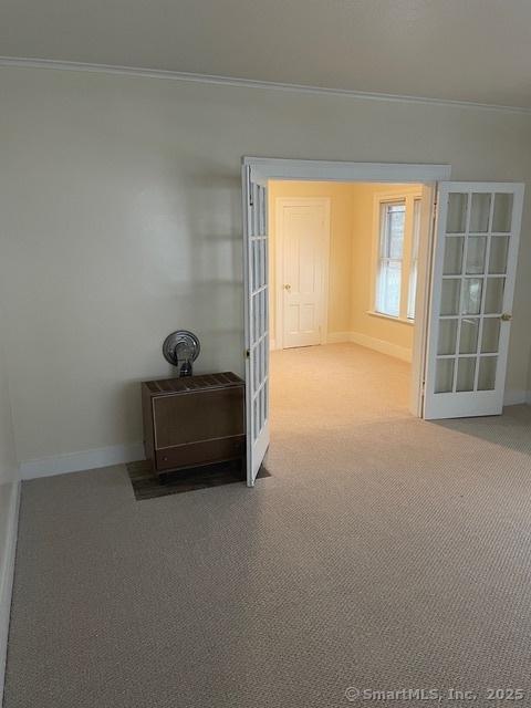 302 High St, Naugatuck, CT 06770 - interior space featuring carpet floors, crown molding, baseboards, and french doors