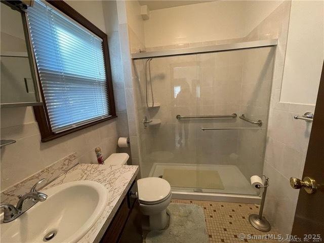 302 High St, Naugatuck, CT 06770 - bathroom featuring vanity, a shower stall, and toilet