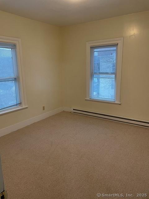 302 High St, Naugatuck, CT 06770 - empty room featuring light colored carpet, a baseboard radiator, and baseboards