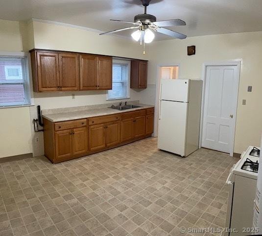 302 High St, Naugatuck, CT 06770 - kitchen featuring brown cabinets, light countertops, a sink, white appliances, and ceiling fan