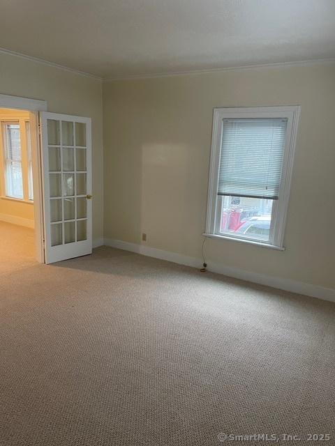 302 High St, Naugatuck, CT 06770 - unfurnished room featuring baseboards, light colored carpet, and ornamental molding
