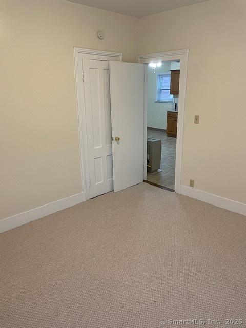 302 High St, Naugatuck, CT 06770 - spare room with baseboards and light colored carpet