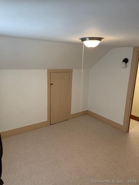 302 High St, Naugatuck, CT 06770 - bonus room with lofted ceiling, baseboards, and light colored carpet