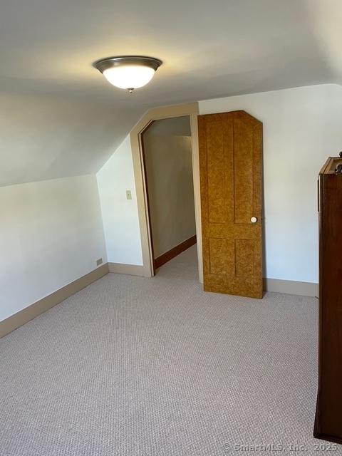 302 High St, Naugatuck, CT 06770 - additional living space featuring light carpet, vaulted ceiling, and baseboards
