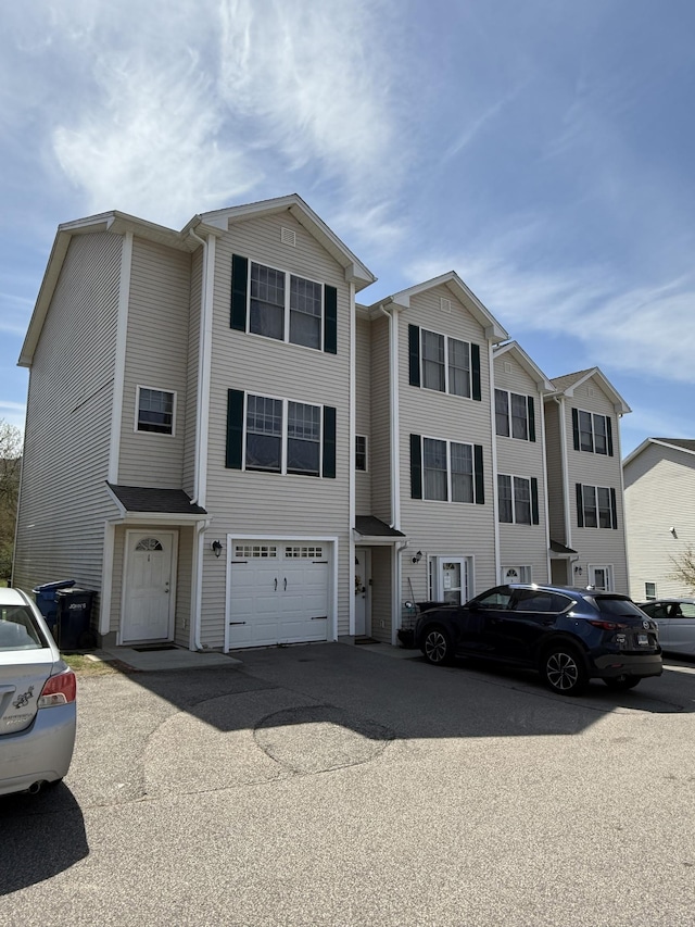 view of property featuring an attached garage and driveway