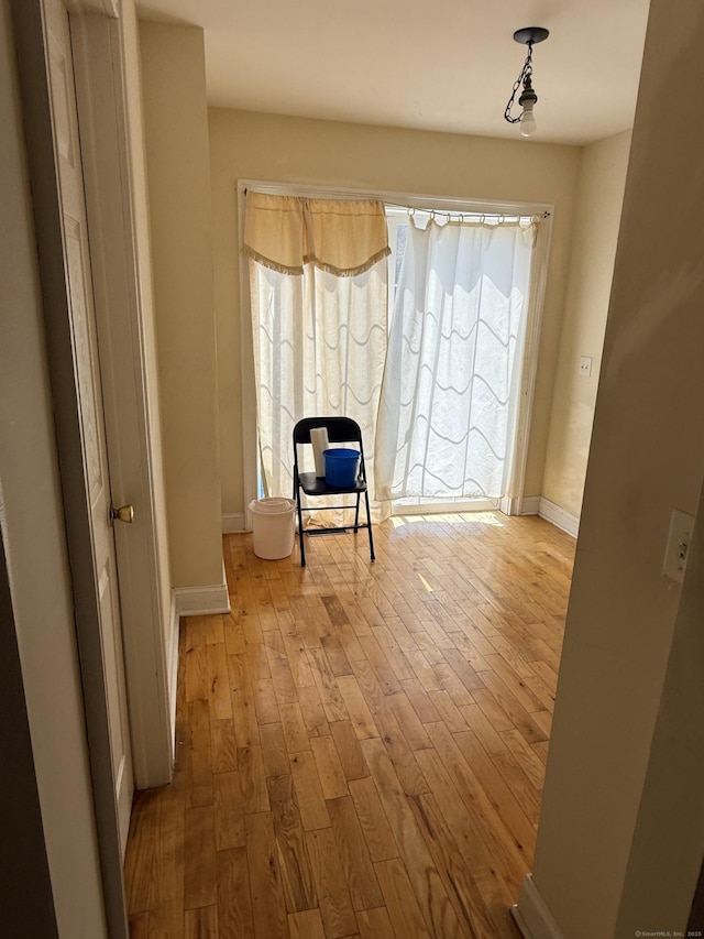sitting room with hardwood / wood-style floors and baseboards
