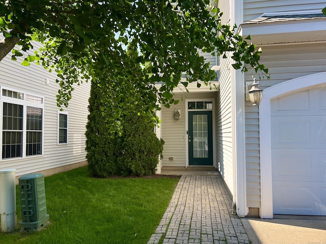 450 Naugatuck Ave Unit 450, Milford, CT 06460 - view of exterior entry featuring an attached garage and a yard