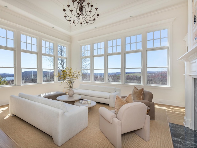 293 Lake Rd, Warren, CT 06777 - living area with healthy amount of natural light, a chandelier, a high end fireplace, baseboards, and ornamental molding