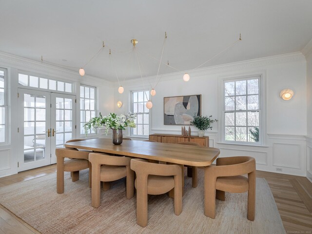 293 Lake Rd, Warren, CT 06777 - dining room with french doors, wainscoting, a decorative wall, and crown molding