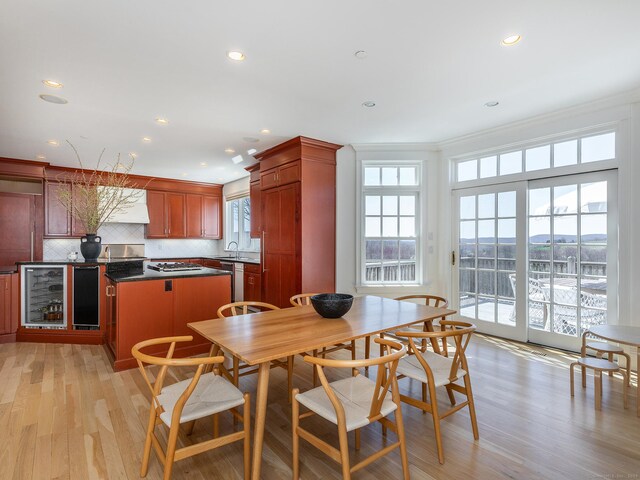 293 Lake Rd, Warren, CT 06777 - dining room with beverage cooler, recessed lighting, light wood-type flooring, and ornamental molding