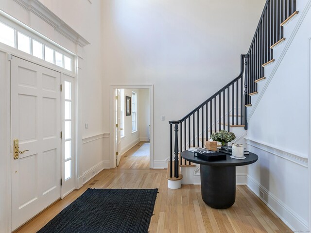 293 Lake Rd, Warren, CT 06777 - foyer entrance with light wood-style floors, stairs, and a towering ceiling