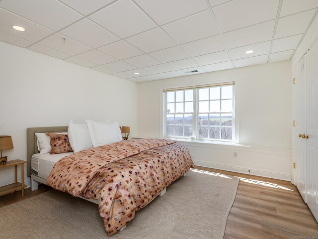 293 Lake Rd, Warren, CT 06777 - bedroom with a drop ceiling, wood finished floors, baseboards, and recessed lighting