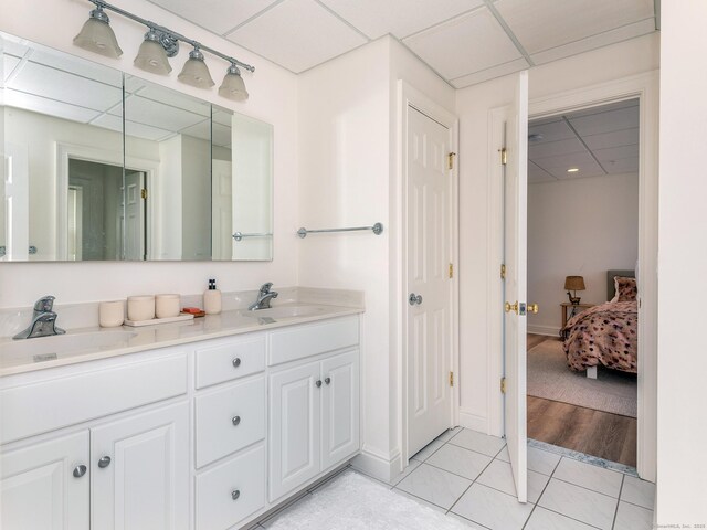 293 Lake Rd, Warren, CT 06777 - bathroom featuring double vanity, tile patterned flooring, ensuite bathroom, a drop ceiling, and baseboards