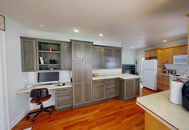 335 Paradise Ave, Hamden, CT 06514 - kitchen with light countertops, light wood-style flooring, white appliances, and built in desk