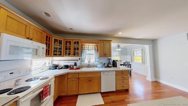 335 Paradise Ave, Hamden, CT 06514 - kitchen with light countertops, light wood-style flooring, glass insert cabinets, and white appliances