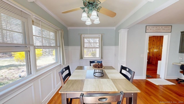 335 Paradise Ave, Hamden, CT 06514 - dining area with ceiling fan, a decorative wall, light wood finished floors, and a wainscoted wall