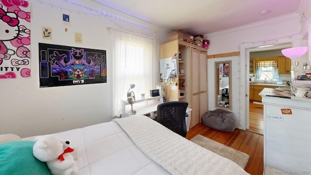 335 Paradise Ave, Hamden, CT 06514 - bedroom featuring ornamental molding, light wood-style flooring, and a sink
