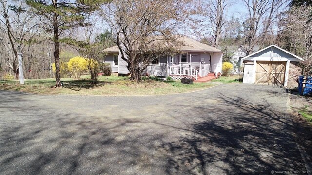 335 Paradise Ave, Hamden, CT 06514 - view of front of house with a chimney, a porch, an outbuilding, a storage shed, and driveway