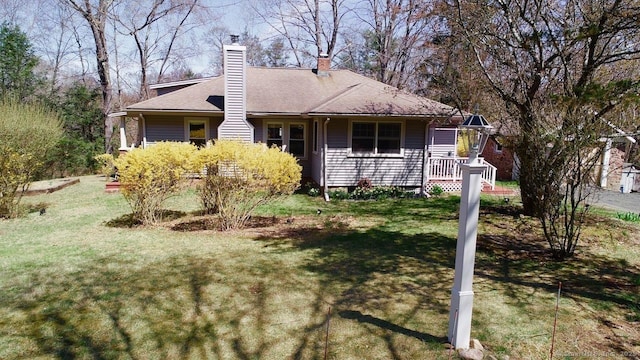 335 Paradise Ave, Hamden, CT 06514 - view of front facade featuring a front lawn and a chimney