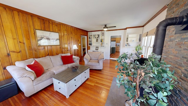 335 Paradise Ave, Hamden, CT 06514 - living area featuring light wood-type flooring, a ceiling fan, ornamental molding, and a wood stove