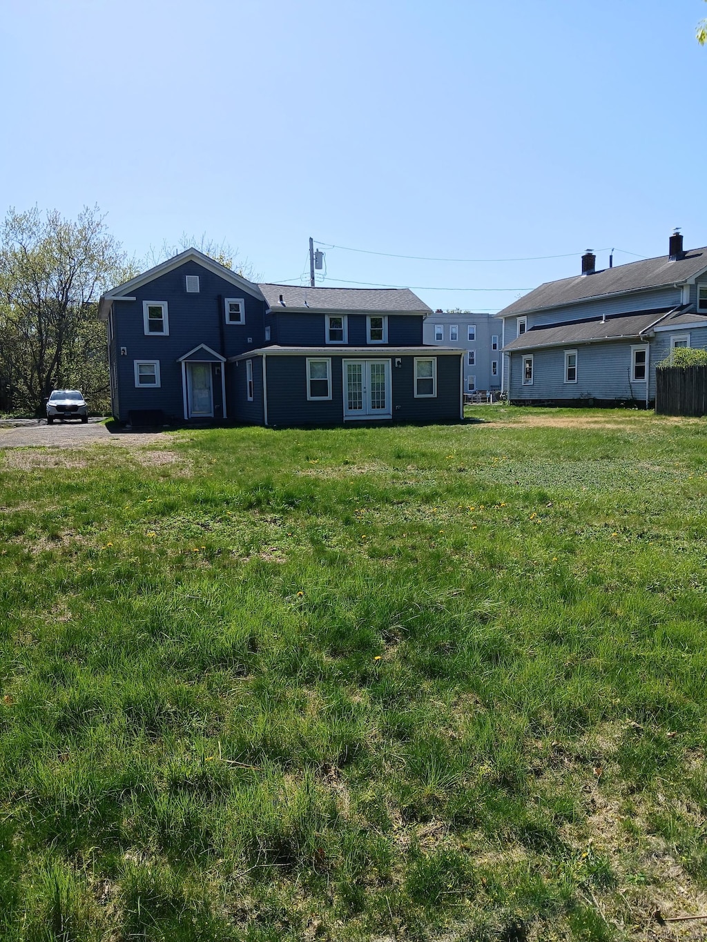 exterior space featuring a yard and french doors