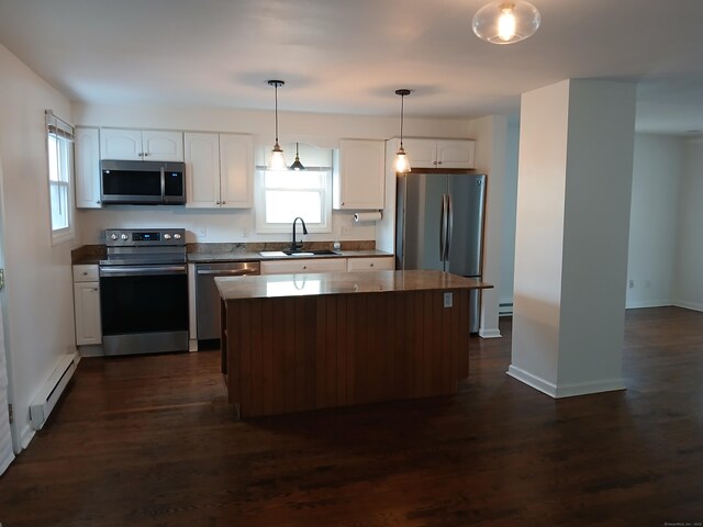 22 Bristol St, Wallingford, CT 06492 - kitchen featuring a sink, dark countertops, white cabinetry, baseboard heating, and appliances with stainless steel finishes