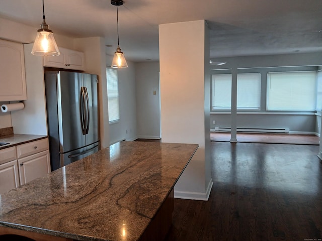 22 Bristol St, Wallingford, CT 06492 - kitchen with freestanding refrigerator, dark wood-style flooring, dark stone counters, and a baseboard heating unit