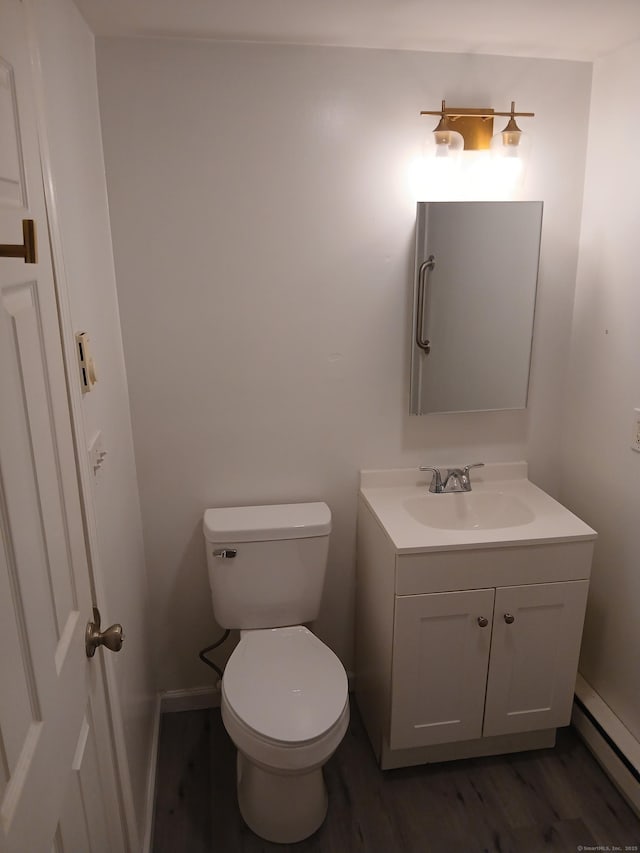 22 Bristol St, Wallingford, CT 06492 - half bathroom featuring toilet, baseboard heating, vanity, and wood finished floors
