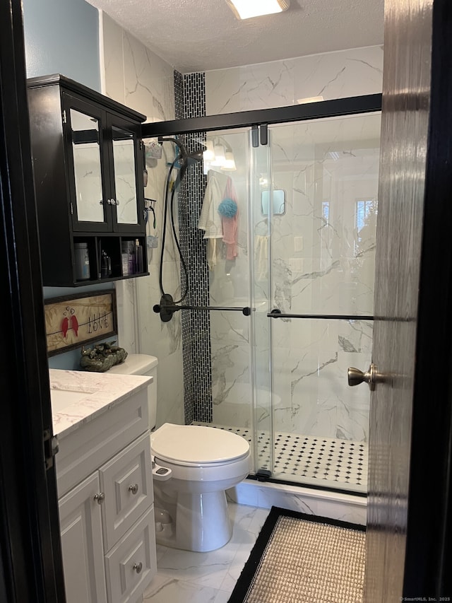 3699 Broadbridge Ave Unit 234, Stratford, CT 06614 - bathroom with a marble finish shower, a textured ceiling, toilet, marble finish floor, and vanity
