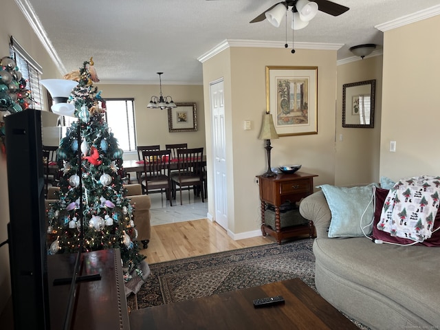 3699 Broadbridge Ave Unit 234, Stratford, CT 06614 - living room featuring wood finished floors, ceiling fan with notable chandelier, a textured ceiling, and ornamental molding