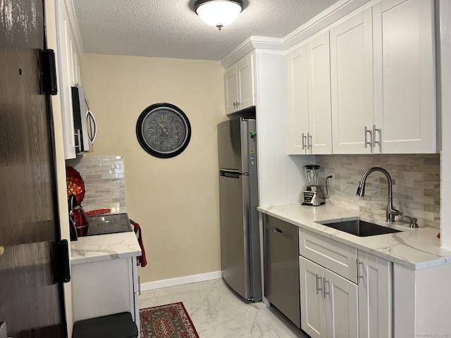 3699 Broadbridge Ave Unit 234, Stratford, CT 06614 - kitchen featuring decorative backsplash, stainless steel appliances, marble finish floor, a sink, and white cabinetry