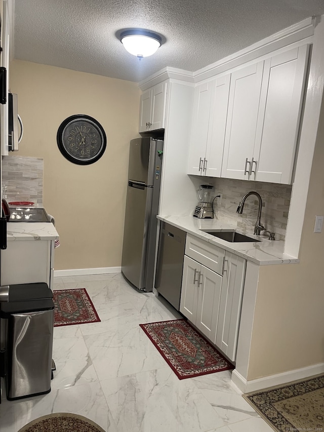 3699 Broadbridge Ave Unit 234, Stratford, CT 06614 - kitchen featuring a sink, tasteful backsplash, marble finish floor, white cabinets, and appliances with stainless steel finishes