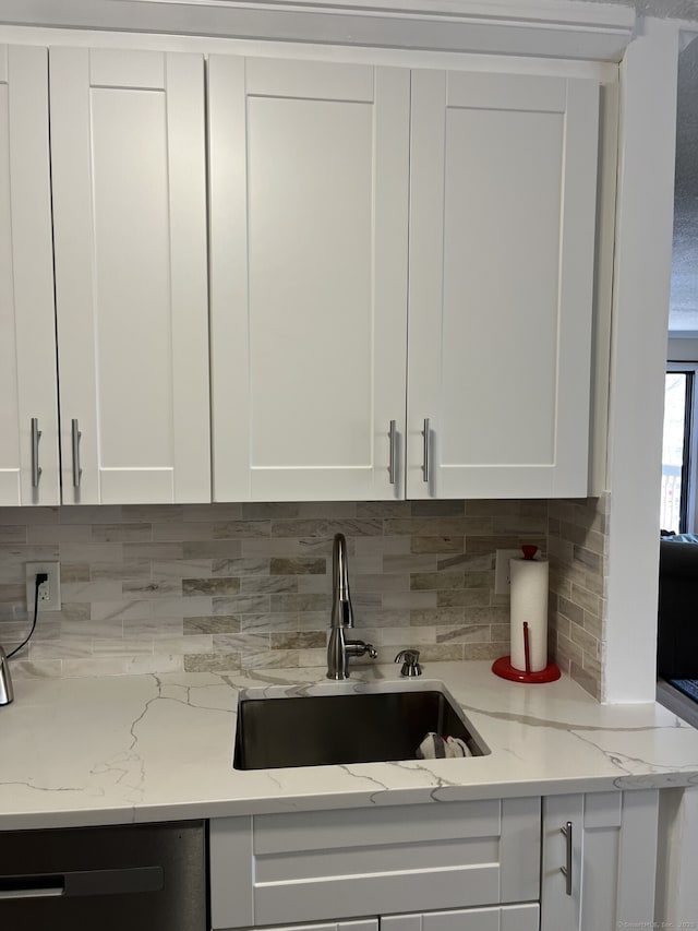 3699 Broadbridge Ave Unit 234, Stratford, CT 06614 - kitchen with white cabinetry, decorative backsplash, a sink, light stone countertops, and dishwasher