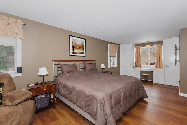 bedroom featuring baseboards and wood finished floors