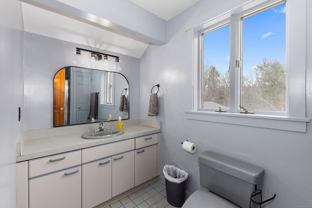 half bath featuring tile patterned floors, vanity, and toilet
