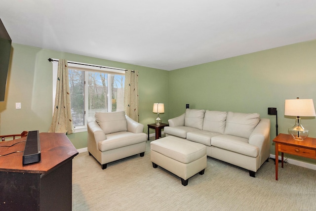 living room featuring light colored carpet and baseboards