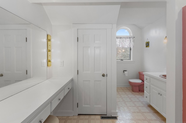 bathroom with toilet, vanity, tile patterned floors, and visible vents