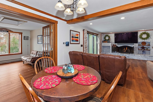 dining space with wood finished floors, recessed lighting, a notable chandelier, and a baseboard radiator
