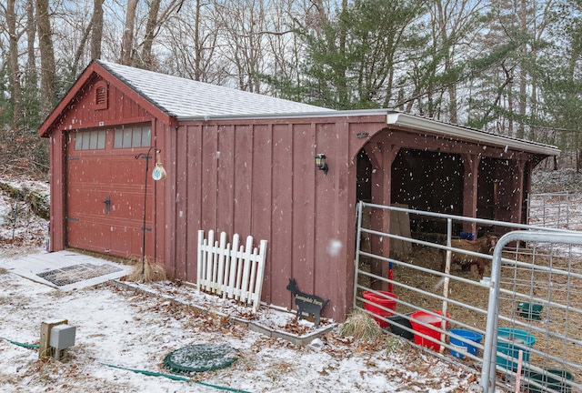 snow covered structure with an exterior structure and an outbuilding