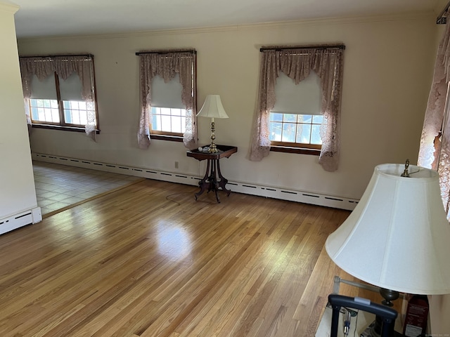 spare room with plenty of natural light, crown molding, and wood finished floors