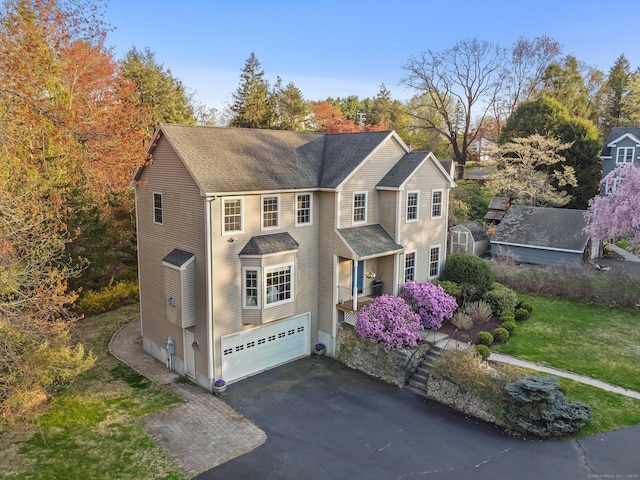 12 Canoe Brook Rd, Trumbull, CT 06611 - view of front facade featuring a front lawn, aphalt driveway, a shingled roof, and an attached garage