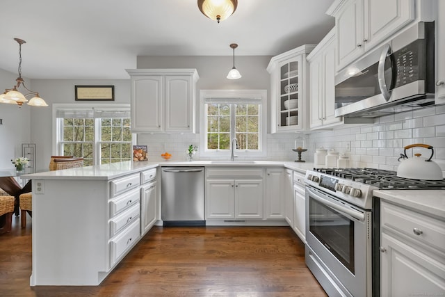 12 Canoe Brook Rd, Trumbull, CT 06611 - kitchen with stainless steel appliances, white cabinets, a peninsula, and a sink