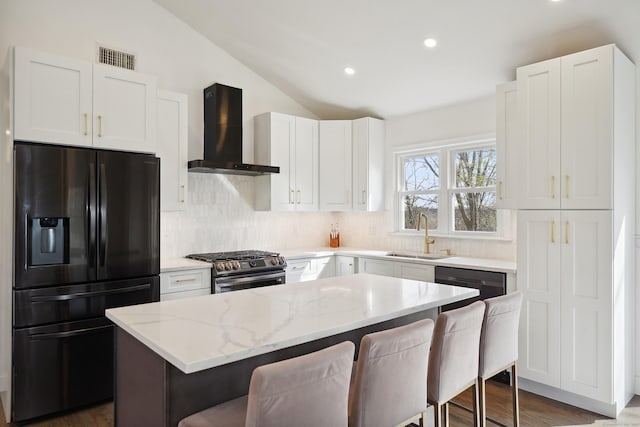 2 Benson Dr, Danbury, CT 06810 - kitchen with a sink, black fridge with ice dispenser, wall chimney exhaust hood, lofted ceiling, and stainless steel range with gas stovetop