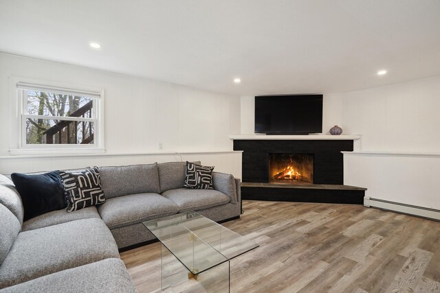 2 Benson Dr, Danbury, CT 06810 - living area featuring baseboard heating, recessed lighting, light wood-style flooring, and a warm lit fireplace